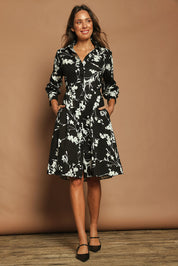 Model Madeline wearing size 10 of The Printed Cotton Stretch Shirt Dress in colour Blackfleur (Black), from the front, showing the whole outfit
