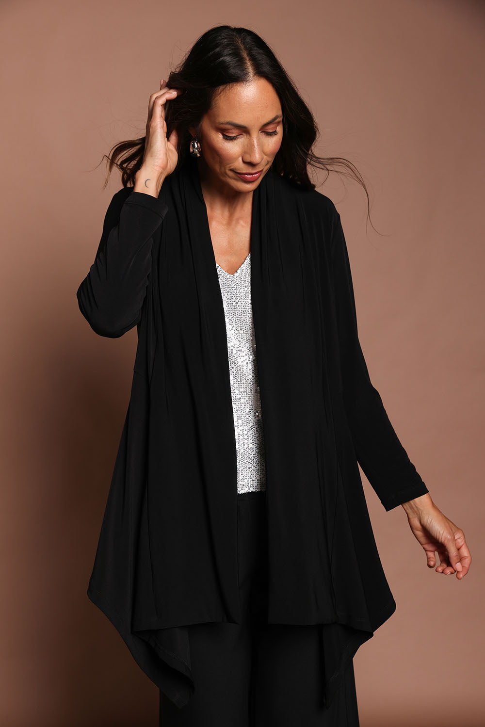 Model Amanda wearing size 10 of The Longline Drape Cardi in colour Black (Black), from the front, showing the whole outfit
