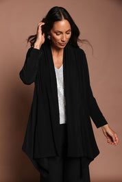 Model Amanda wearing size 10 of The Longline Drape Cardi in colour Black (Black), from the front, showing the whole outfit