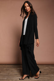Model Amanda wearing size 10 of The Longline Drape Cardi in colour Black (Black), from the front, showing the whole outfit