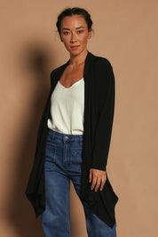 Model Katie wearing size 10 of The Longline Drape Cardi in colour Black (Black), from the front, cropped image
