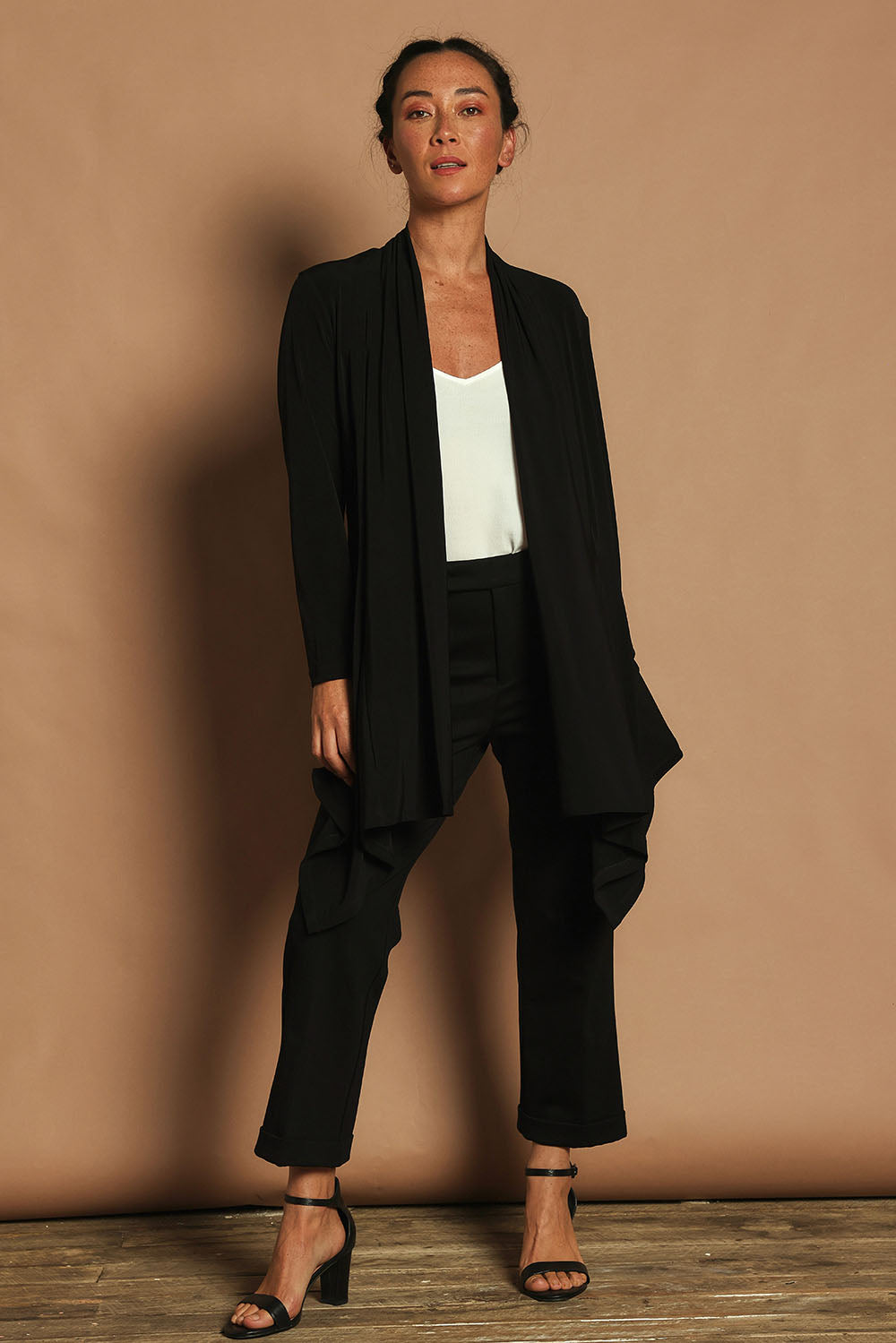 Model Katie wearing size 10 of The Longline Drape Cardi in colour Black (Black), from the front, showing the whole outfit