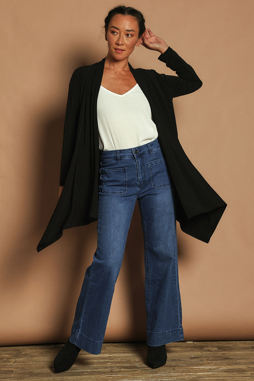 Model Katie wearing size 10 of The Longline Drape Cardi in colour Black (Black), from the front, showing the whole outfit