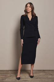 Model Madeline wearing size S of The Crepe Knit Multiway Pull On Skirt in colour Black (Black), from the front, showing the whole outfit
