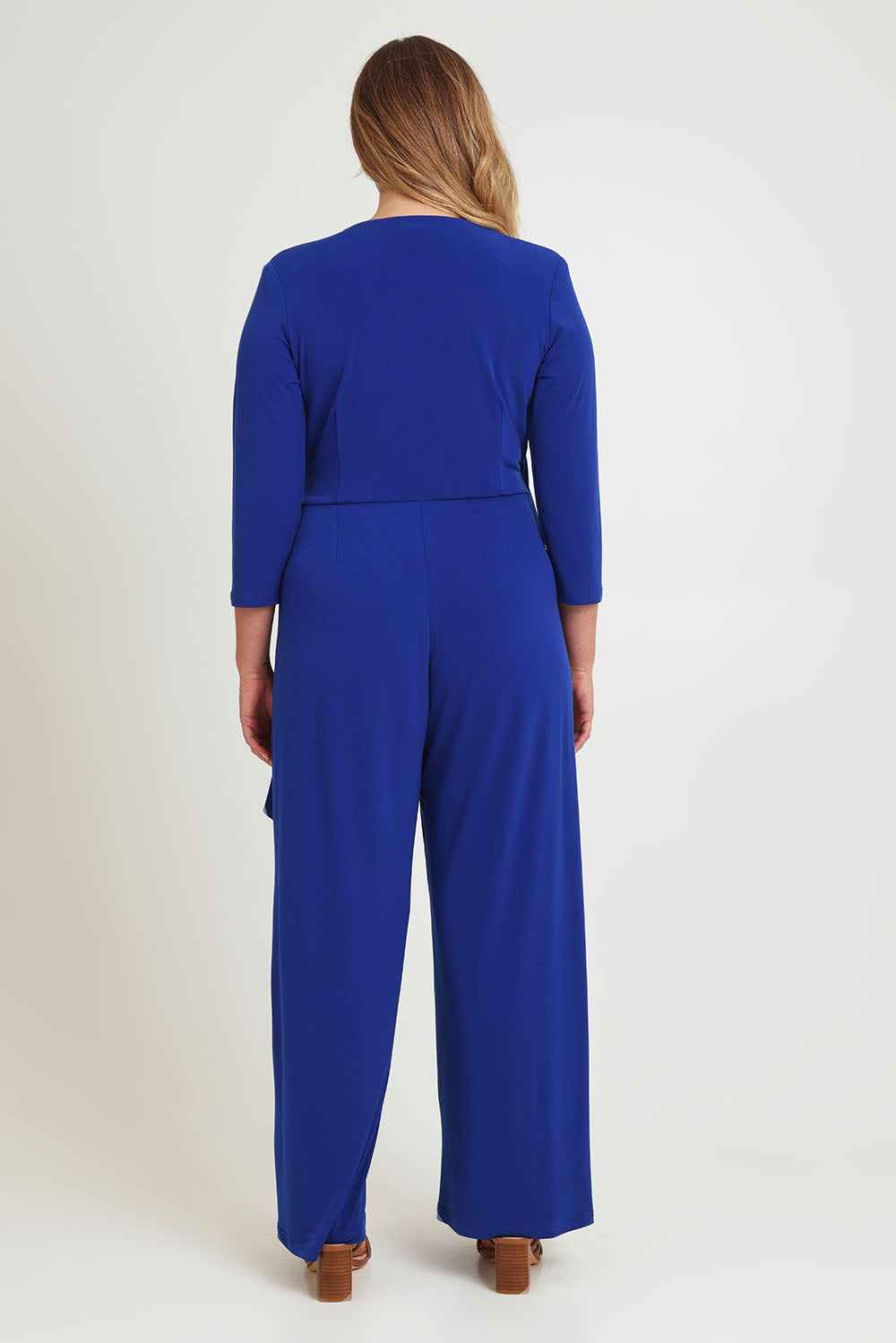 Model Chanel wearing size 16 of The Tie Waist Jumpsuit in colour Royalblue (Blue), from the back