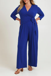 Model Chanel wearing size 16 of The Tie Waist Jumpsuit in colour Royalblue (Blue), from the front, cropped image