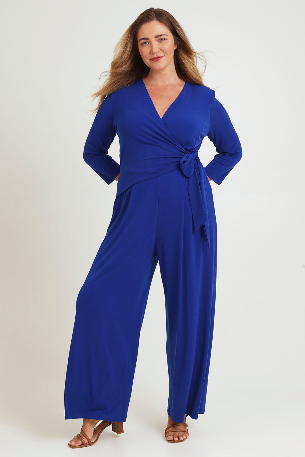 Model Chanel wearing size 16 of The Tie Waist Jumpsuit in colour Royalblue (Blue), from the front, showing the whole outfit