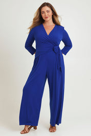 Model Chanel wearing size 16 of The Tie Waist Jumpsuit in colour Royalblue (Blue), from the front, showing the whole outfit