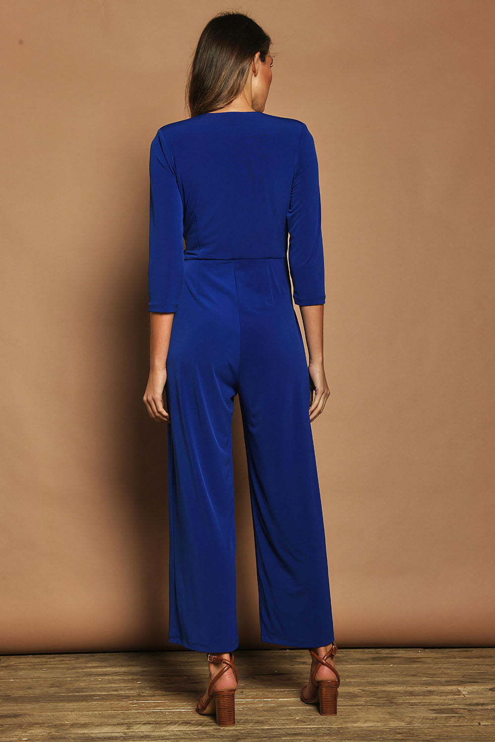 Model Madeline wearing size 10 of The Tie Waist Jumpsuit in colour Royalblue (Blue), from the back