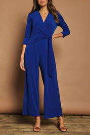 Model Madeline wearing size 10 of The Tie Waist Jumpsuit in colour Royalblue (Blue), from the front, cropped image