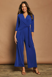 Model Madeline wearing size 10 of The Tie Waist Jumpsuit in colour Royalblue (Blue), from the front, showing the whole outfit