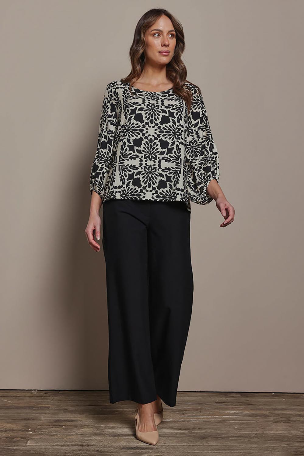 Model Madeline wearing size 10 of The Printed Bishop Sleeve Blouse in colour Black (Black), from the front, showing the whole outfit