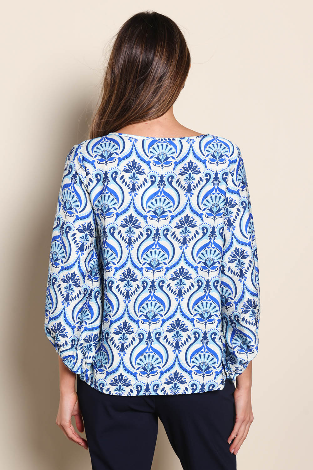 Model Madelinec wearing size 10 of the The Printed Bishop Sleeve Blouse – Bluedamask in colour Bluedamask, from the back