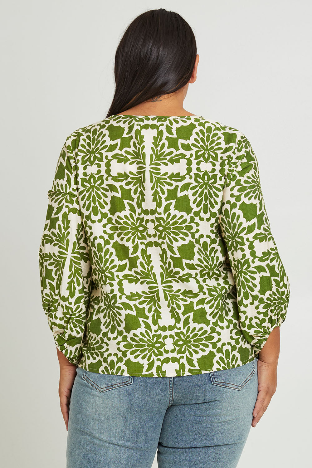 Model Ashleigh wearing size 16 of The Printed Bishop Sleeve Blouse in colour Green (Green), from the back