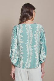 Model Madeline wearing size 10 of The Printed Bishop Sleeve Blouse in colour Seafoam (Green), from the back