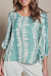 Model Madeline wearing size 10 of The Printed Bishop Sleeve Blouse in colour Seafoam (Green), from the front, cropped image
