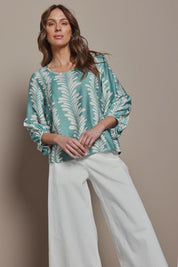 Model Madeline wearing size 10 of The Printed Bishop Sleeve Blouse in colour Seafoam (Green), from the front, showing the whole outfit
