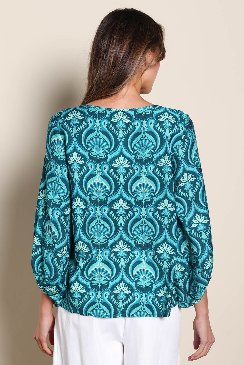 Model Madelinec wearing size 10 of the The Printed Bishop Sleeve Blouse – Tealdamask in colour Tealdamask, from the back