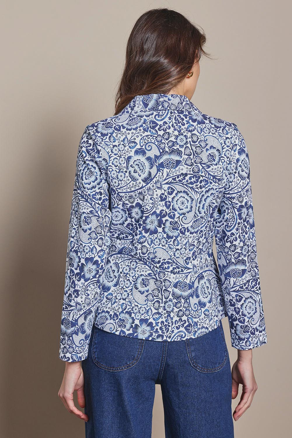 Model Madeline wearing size 10 of The Aspire Blazer in colour Peony (Blue), from the back