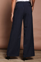 Model Amanda wearing size 10 of The Wide Leg Stripe Pant in colour Navy (Blue), from the back