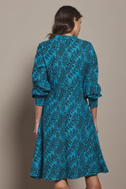 Model Madeline wearing size 10 of The Printed Cotton Button Through Dress in colour Tealbamboo (Blue), from the back