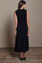Model Madeline wearing size S of The Crepe Knit Button Detail Dress in colour Black (Black), from the back