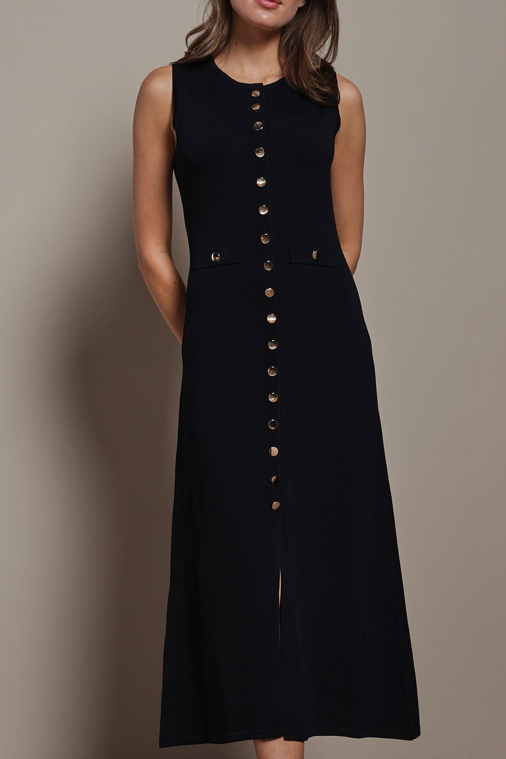 Model Madeline wearing size S of The Crepe Knit Button Detail Dress in colour Black (Black), from the front, cropped image
