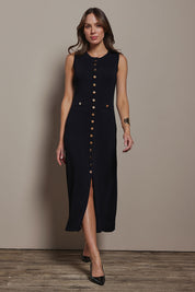 Model Madeline wearing size S of The Crepe Knit Button Detail Dress in colour Black (Black), from the front, showing the whole outfit