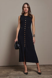 Model Madeline wearing size S of The Crepe Knit Button Detail Dress in colour Black (Black), from the front, showing the whole outfit