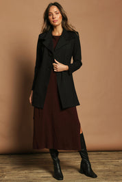 Model Madeline wearing size 10 of The Ponte Longline Collar Jacket in colour Black (Black), from the front, showing the whole outfit
