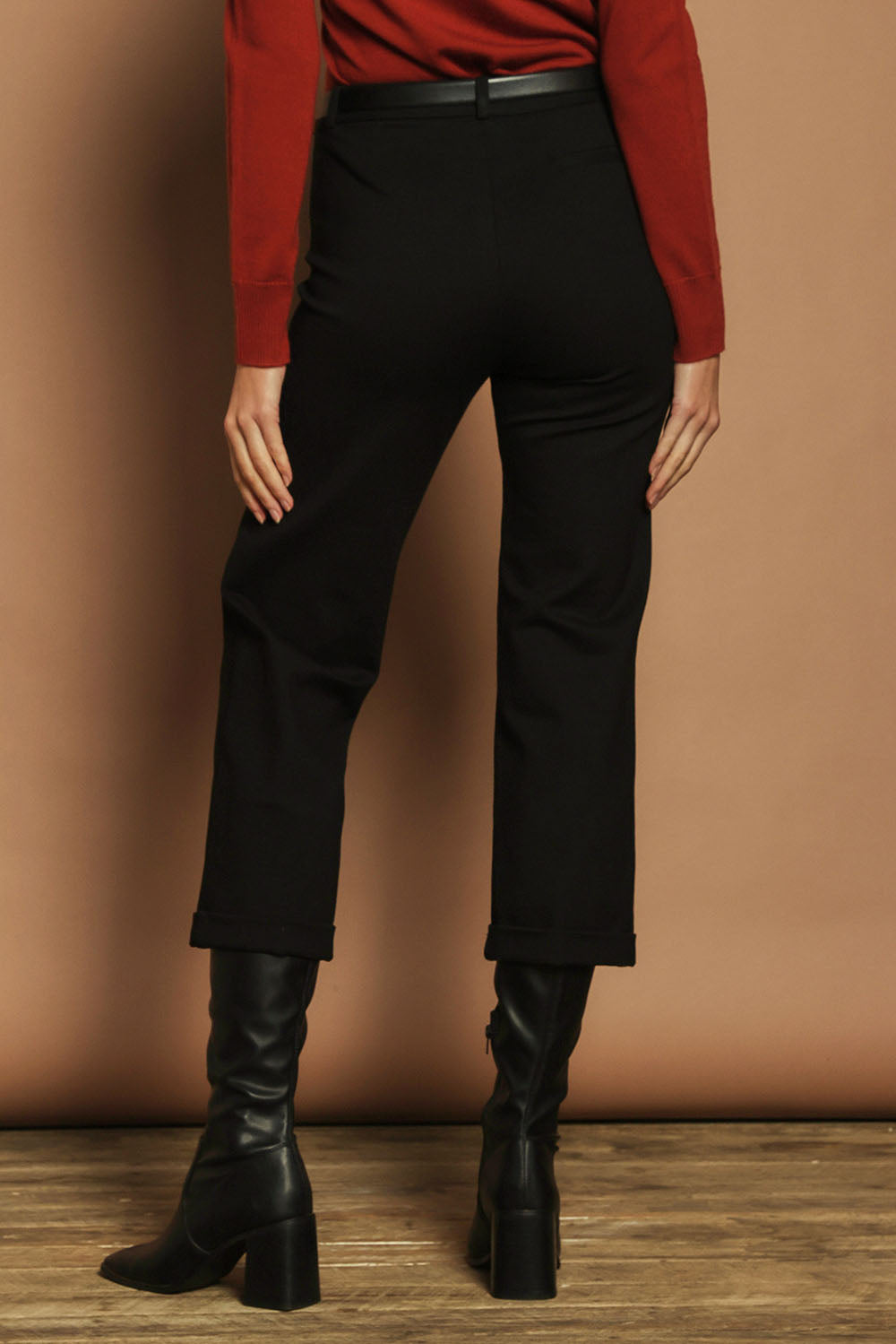 Model Madeline wearing size 10 of The Ponte Tailored 7/8 Pant in colour Black (Black), from the back