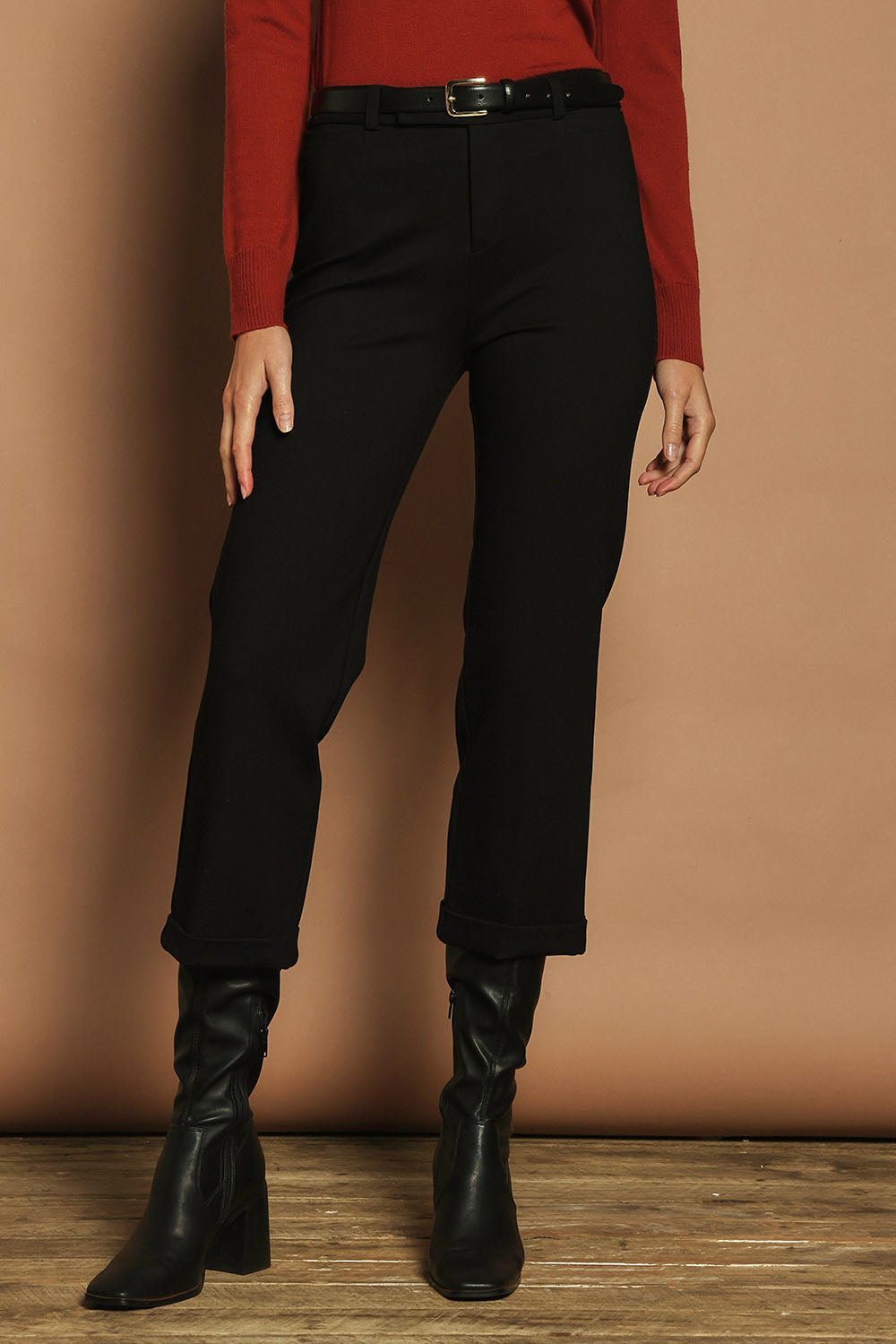Model Madeline wearing size 10 of The Ponte Tailored 7/8 Pant in colour Black (Black), from the front, cropped image