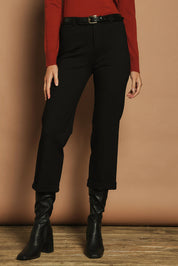Model Madeline wearing size 10 of The Ponte Tailored 7/8 Pant in colour Black (Black), from the front, cropped image