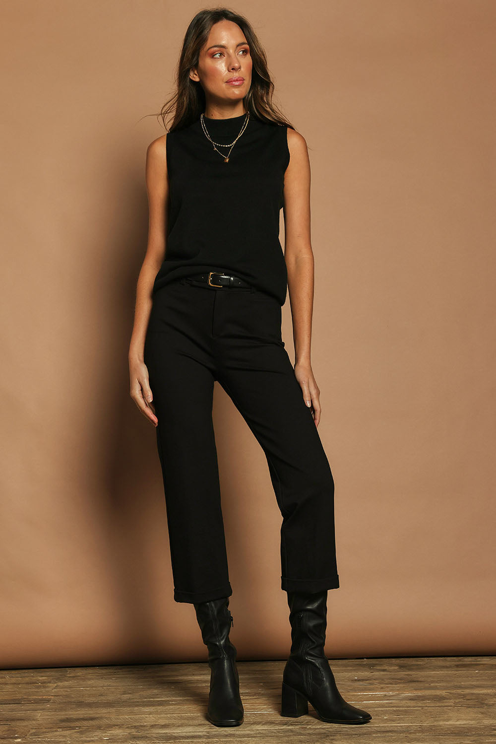 Model Madeline wearing size 10 of The Ponte Tailored 7/8 Pant in colour Black (Black), from the front, showing the whole outfit