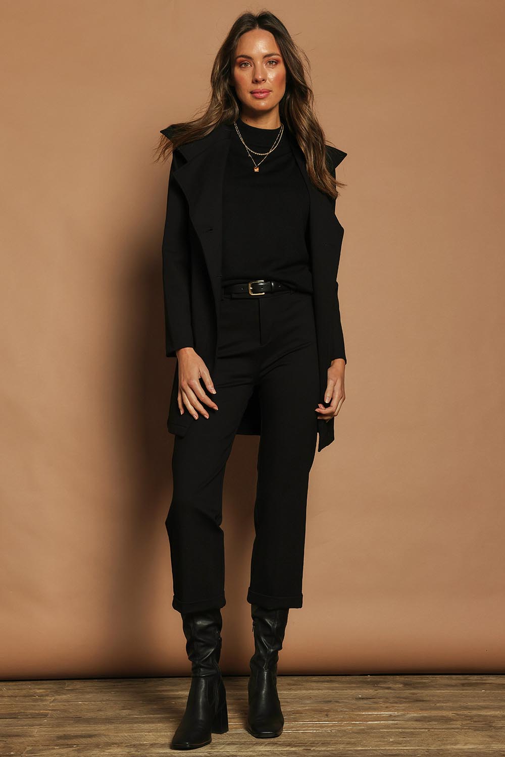 Model Madeline wearing size 10 of The Ponte Tailored 7/8 Pant in colour Black (Black), from the front, showing the whole outfit