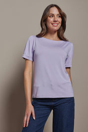 Model Madeline wearing size 10 of The Bamboo Boat Neck Short Sleeve Top in colour Lilac (Purple), from the front, cropped image