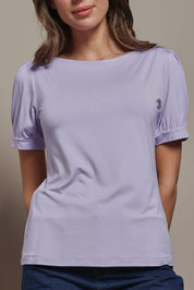 Model Madeline wearing size 10 of The Bamboo Boat Neck Short Sleeve Top in colour Lilac (Purple), from the front, cropped image