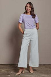 Model Madeline wearing size 10 of The Bamboo Boat Neck Short Sleeve Top in colour Lilac (Purple), from the front, showing the whole outfit