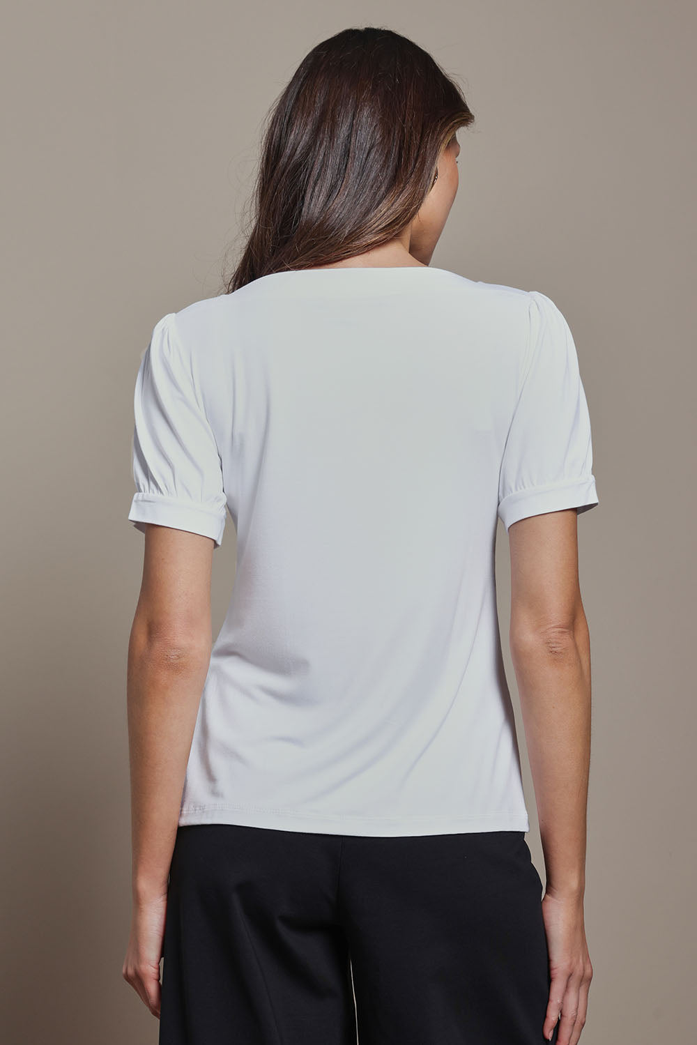 Model Madeline wearing size 10 of The Bamboo Boat Neck Short Sleeve Top in colour Snow (White), from the back
