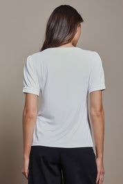 Model Madeline wearing size 10 of The Bamboo Boat Neck Short Sleeve Top in colour Snow (White), from the back
