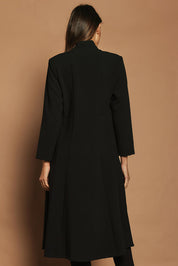 Model Madeline wearing size 10 of The Longline Coatigan in colour Black (Black), from the back
