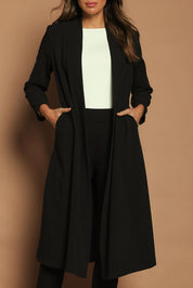Model Madeline wearing size 10 of The Longline Coatigan in colour Black (Black), from the front, cropped image