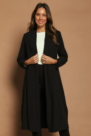 Model Madeline wearing size 10 of The Longline Coatigan in colour Black (Black), from the front, cropped image