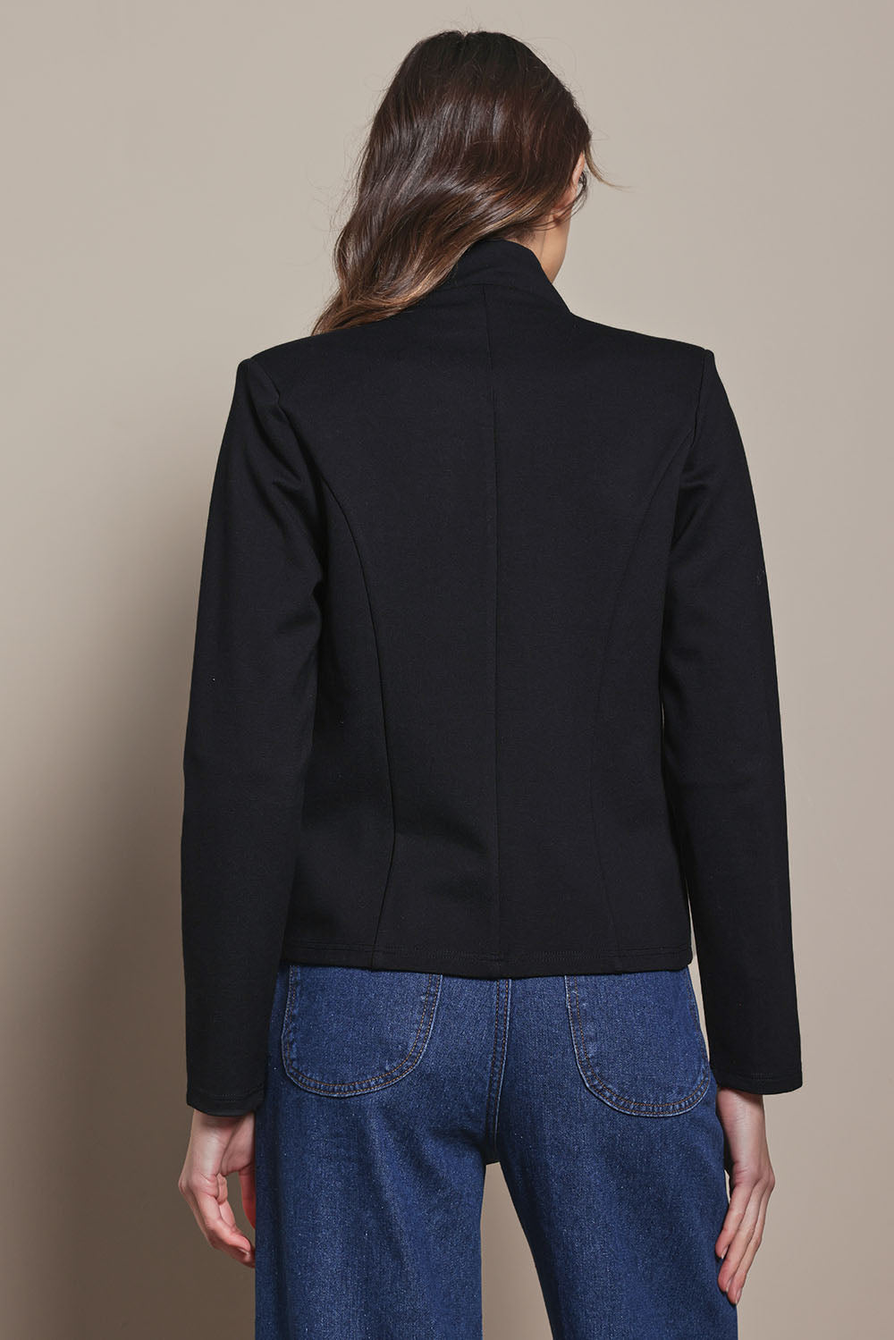 Model Madeline wearing size 10 of The Reverse Lapel Ponte Blazer in colour Jetblack (Black), from the back