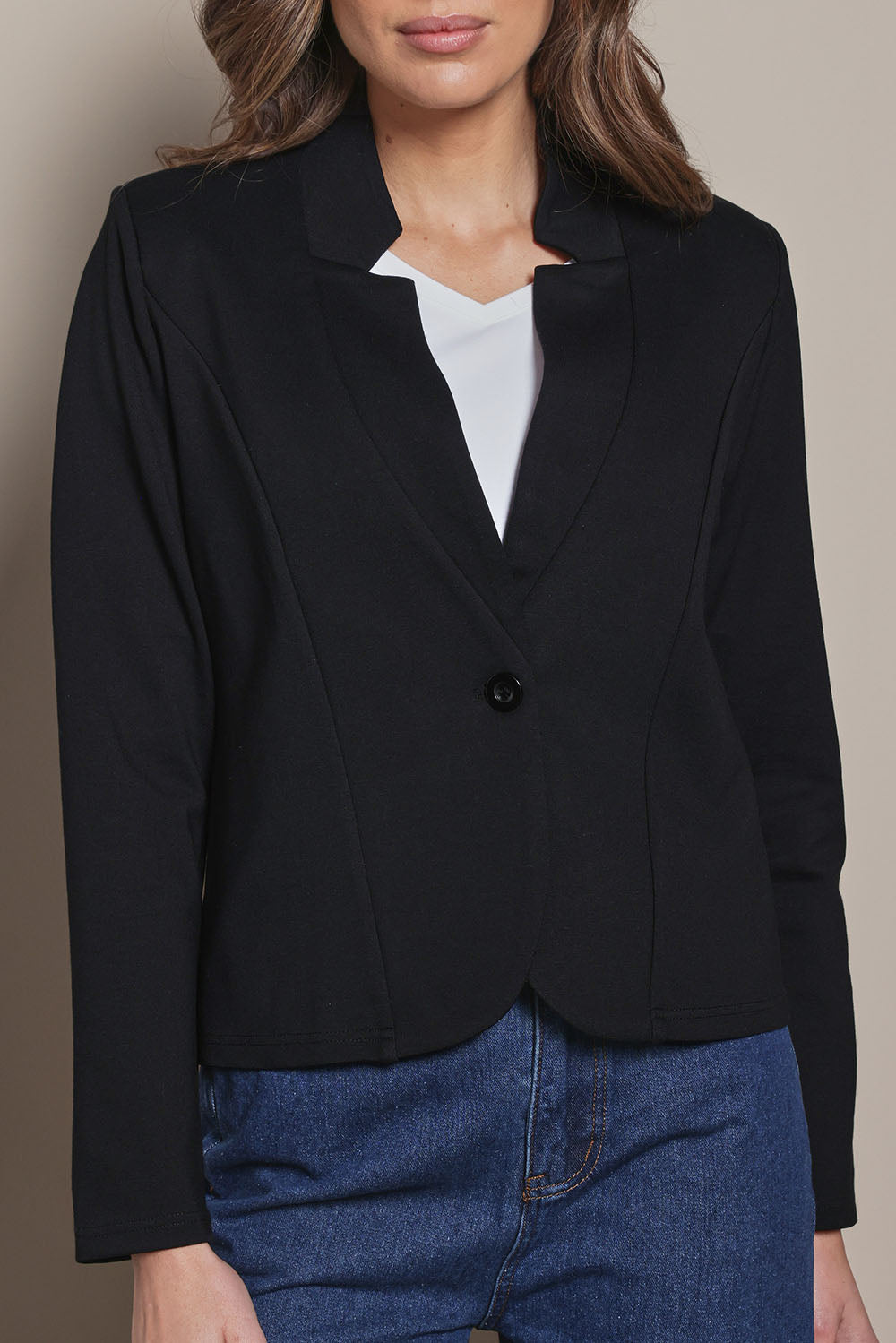 Model Madeline wearing size 10 of The Reverse Lapel Ponte Blazer in colour Jetblack (Black), from the front, cropped image