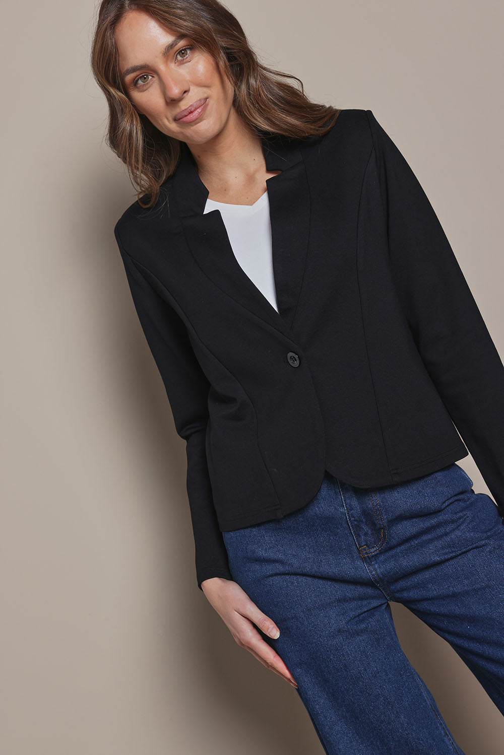 Model Madeline wearing size 10 of The Reverse Lapel Ponte Blazer in colour Jetblack (Black), from the front, cropped image