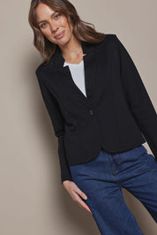 Model Madeline wearing size 10 of The Reverse Lapel Ponte Blazer in colour Jetblack (Black), from the front, cropped image