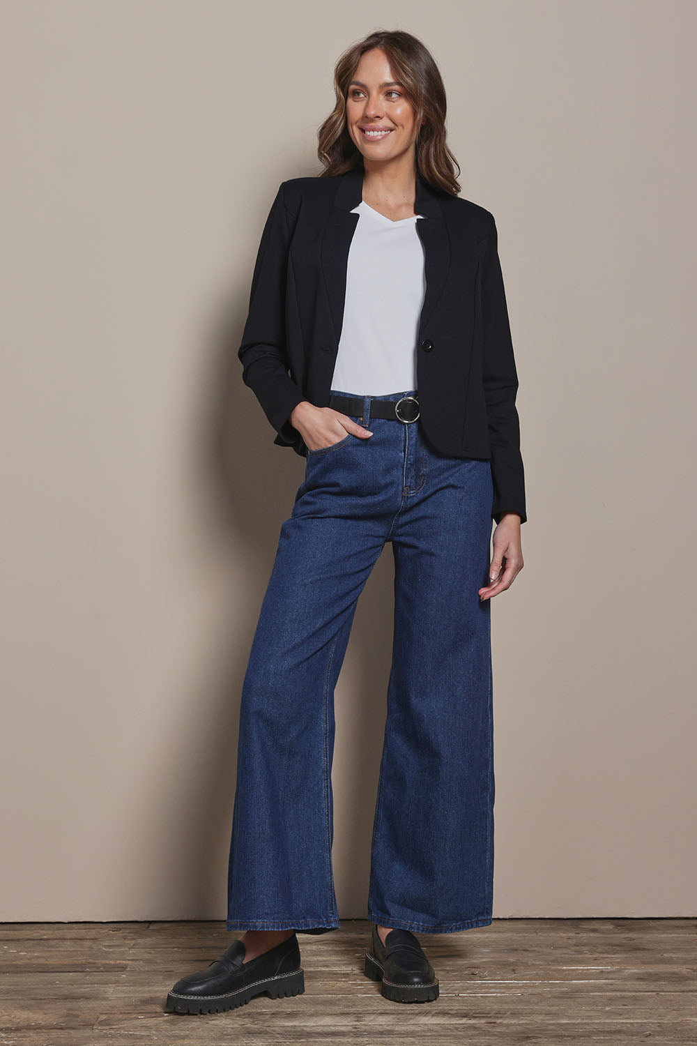 Model Madeline wearing size 10 of The Reverse Lapel Ponte Blazer in colour Jetblack (Black), from the front, showing the whole outfit