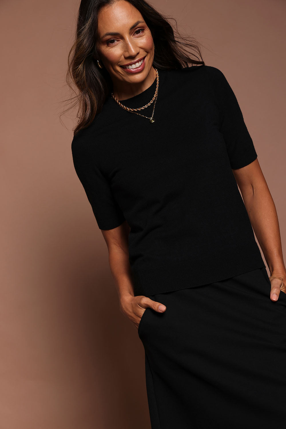 Model Katie wearing size S of The Seamless Soft Crew Neck Knit in colour Black (Black), from the front, showing the whole outfit
