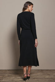 Model Madeline wearing size S of The Tie Waist Faux Wrap Knit Dress in colour Black (Black), from the back